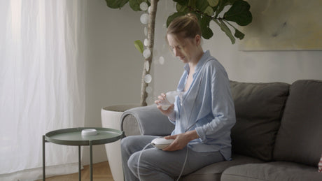 Mother using a NUK breast pump
