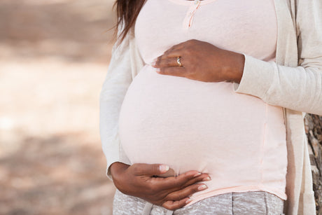 Pregnant female holding her belly