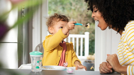 Toddler playing with food