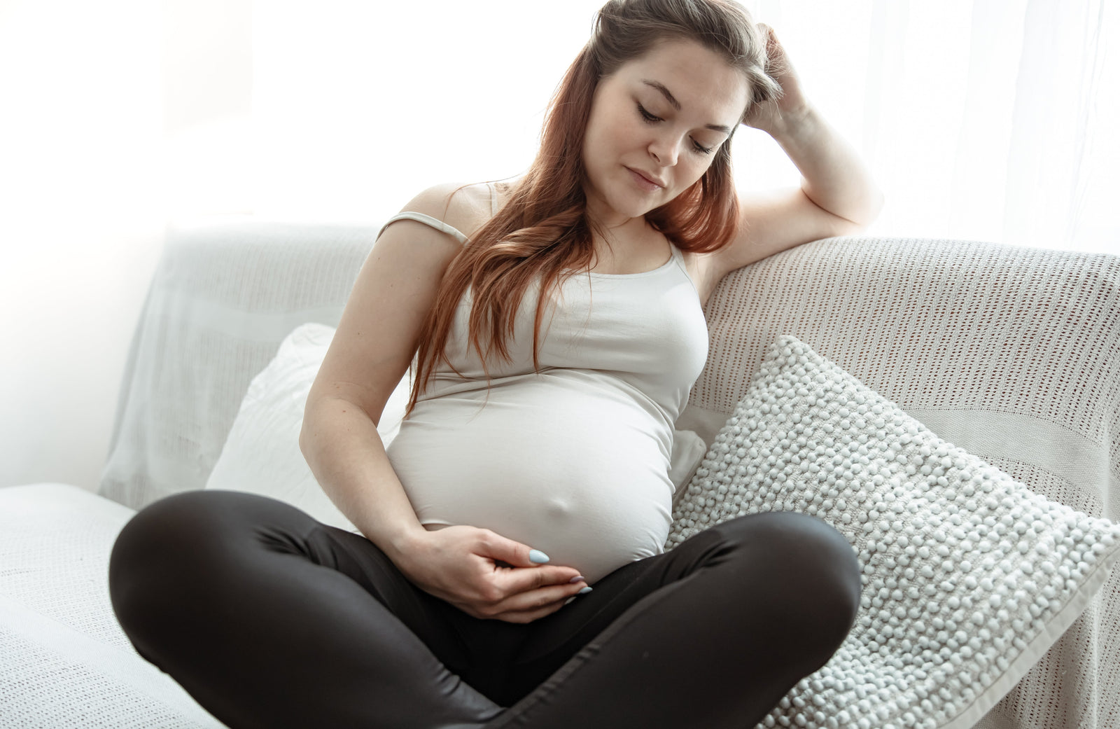 Pregnant female holding her belly