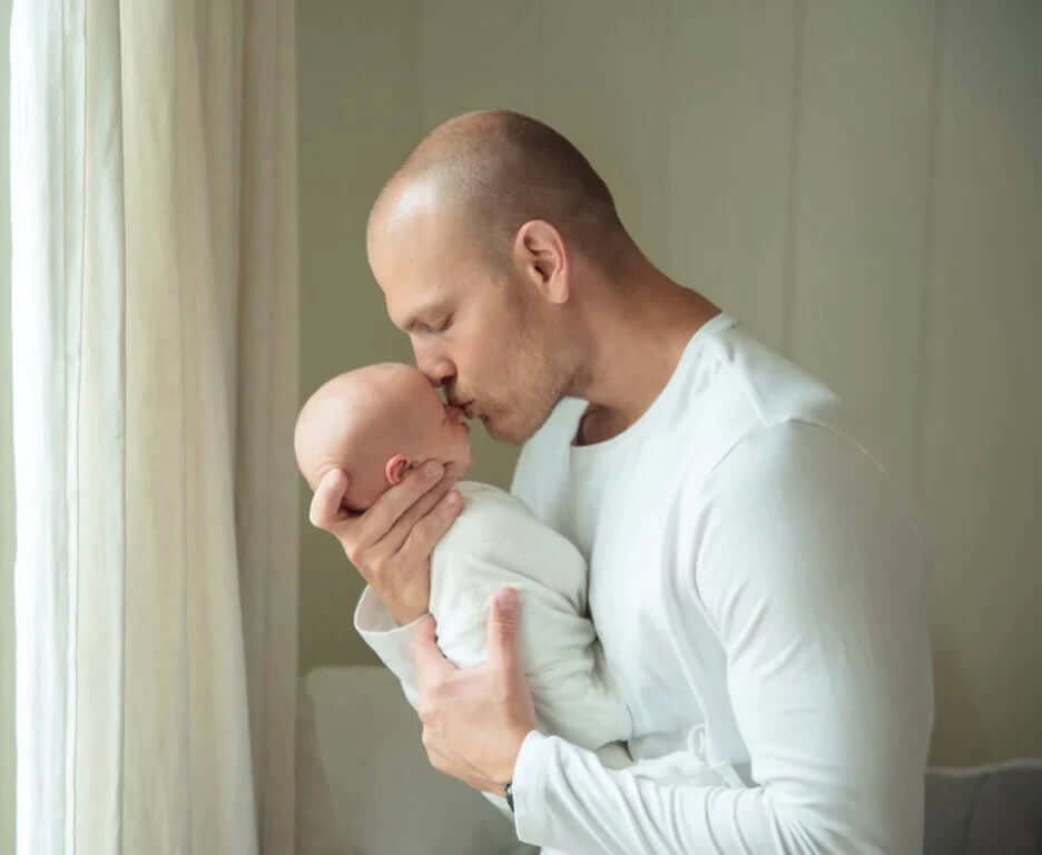 Dad kissing toddler