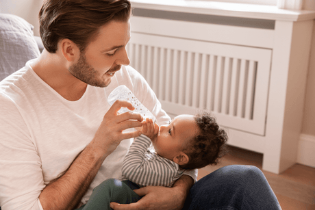 Dad feeding baby with NUK bottle