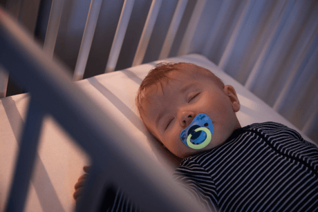 Baby sleeping with NUK Glow-in-the-dark soother