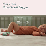Child lying in bed with a health monitor on their wrist, displaying pulse rate and oxygen levels.